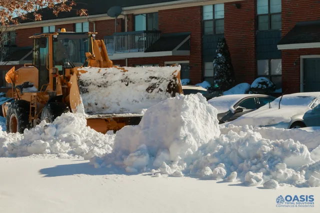 Wheel loader clearing an apartment parking lot