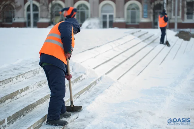 Crew clearing snow from outdoor steps with shovels
